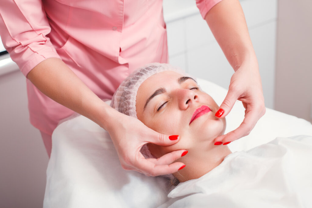 Woman receiving relaxing facial treatment