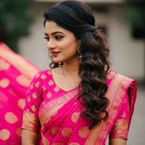 side-swept curls hairstyle for a saree